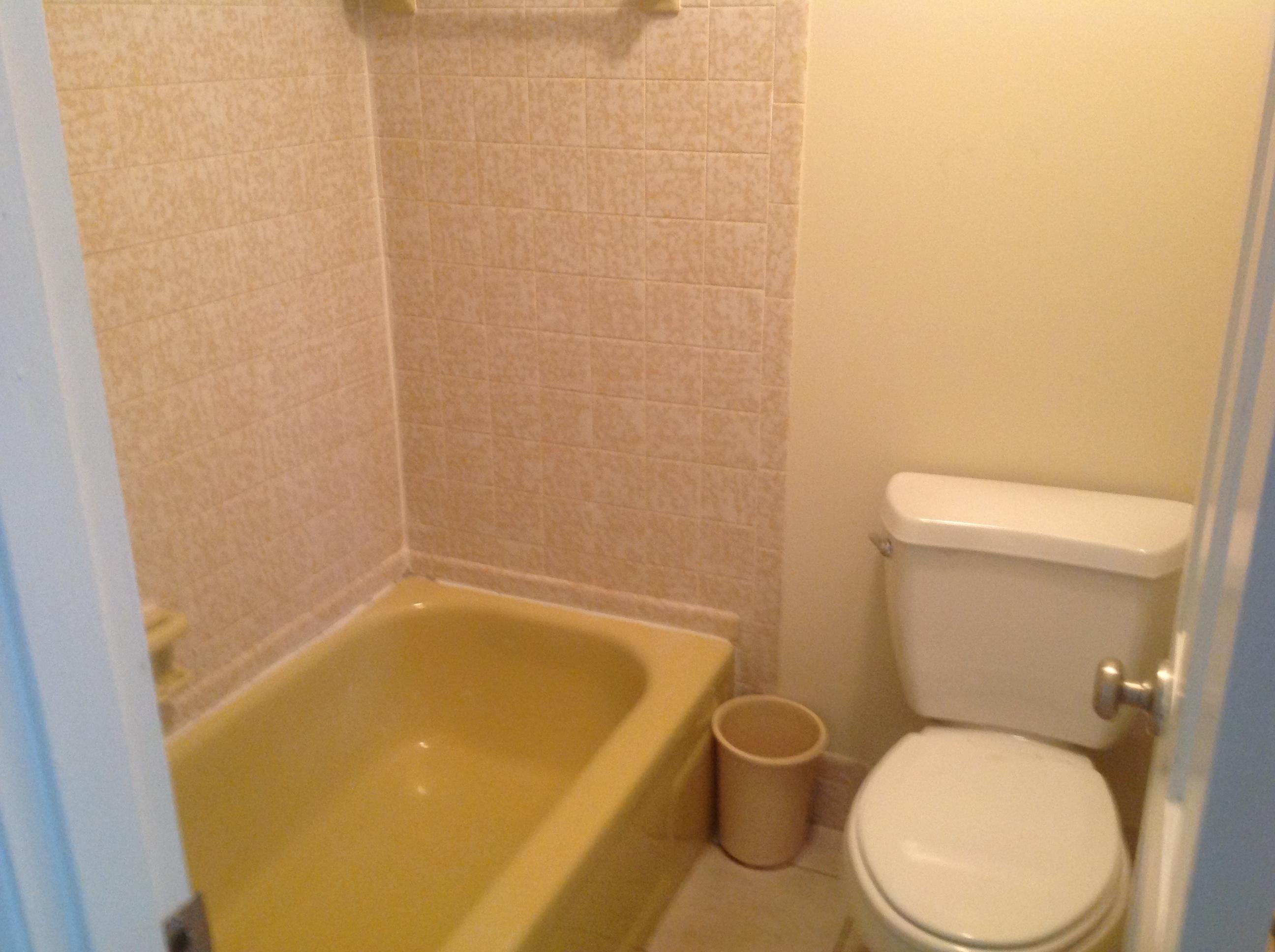 1545 Southeast Pitcher Road Port St. Lucie, FL 34952 - Photo 12 of 22 a white toilet sitting next to a bath tub