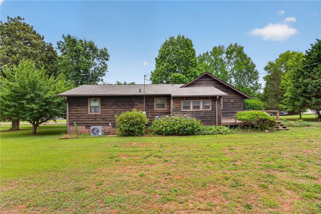 112 Holliday Lane Pendleton, SC 29670 - Photo 39 of 42 A charming wooden house with lush green landscaping awaits new owners.