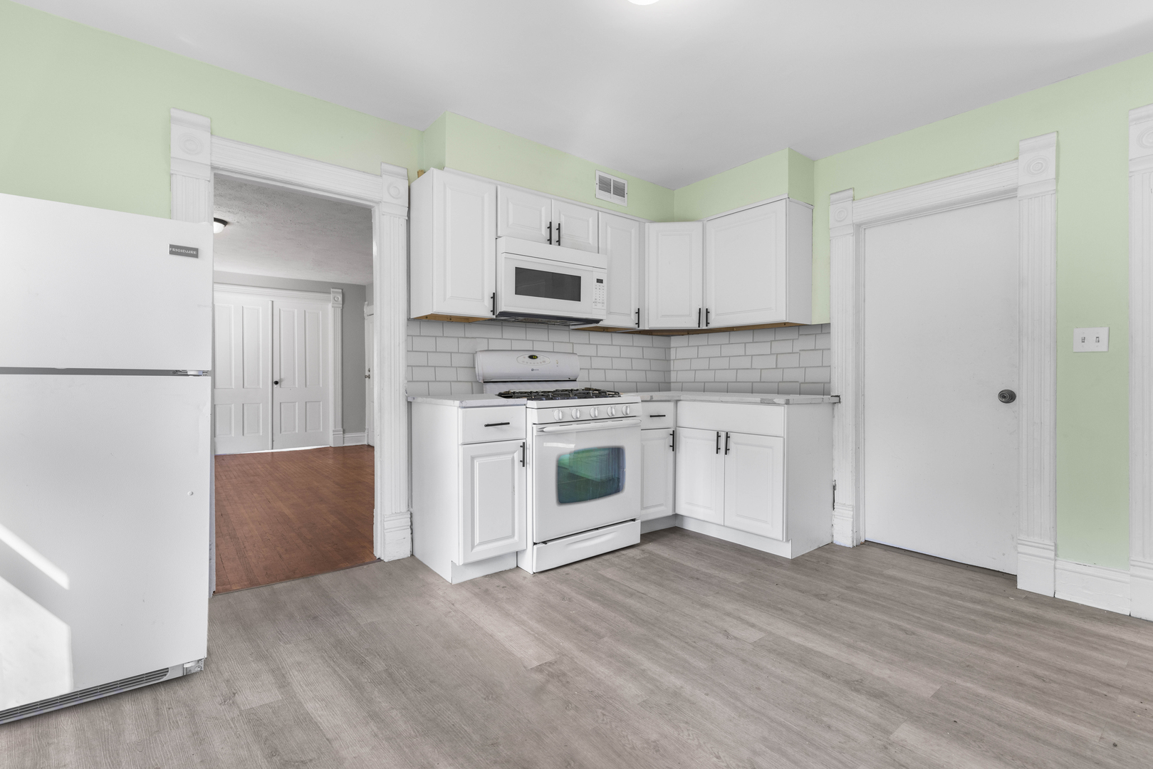 1710 7th Street Rockford, IL 61104 - Photo 11 of 13 a kitchen with white cabinets and white appliances