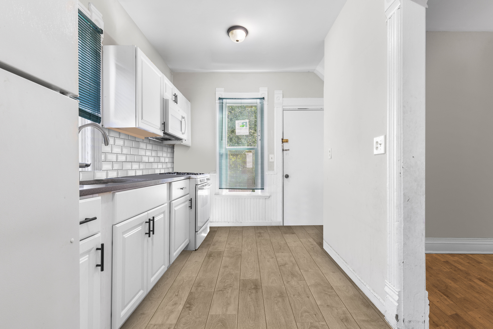 1710 7th Street Rockford, IL 61104 - Photo 13 of 13 a kitchen with granite countertop a stove and wooden floor