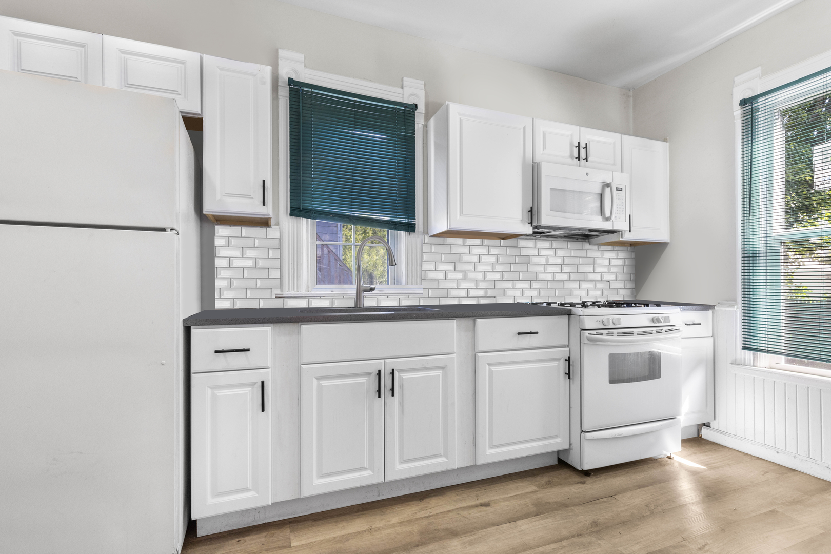 1710 7th Street Rockford, IL 61104 - Photo 7 of 13 a kitchen with stainless steel appliances granite countertop a sink stove and refrigerator