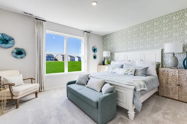 a bedroom with a bed couch and a window