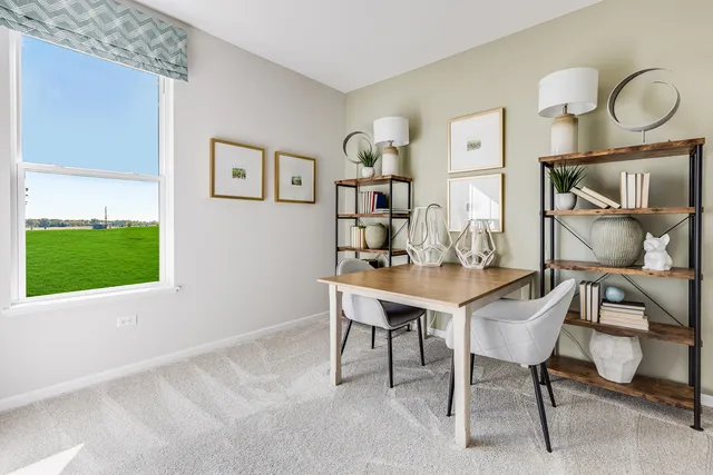 a view of a dining room with furniture and a window