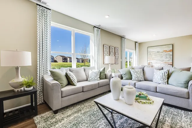 a living room with furniture lamp and window