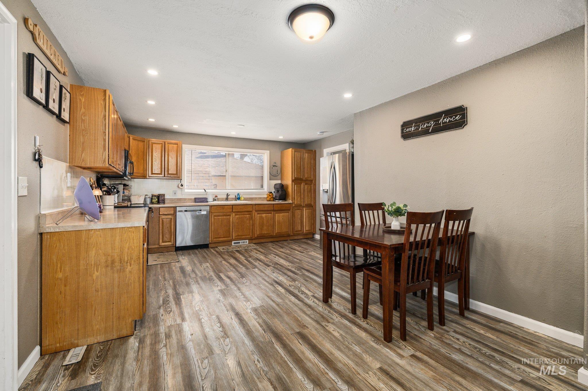 1504 2nd Street North Nampa, ID 83687 - Photo 9 of 29 Kitchen with light countertops, wood finish cabinetry, stainless steel appliances, dark wood finished floors, and recessed lighting