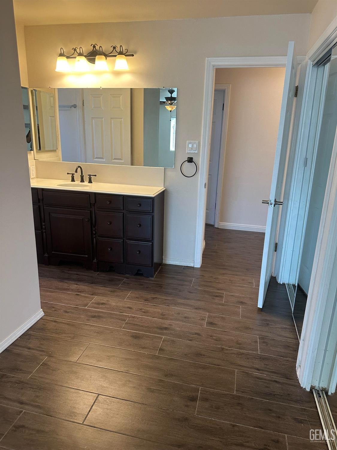 Undisclosed Address Bakersfield, CA 93306 - Photo 13 of 27 a bathroom with a sink and a mirror