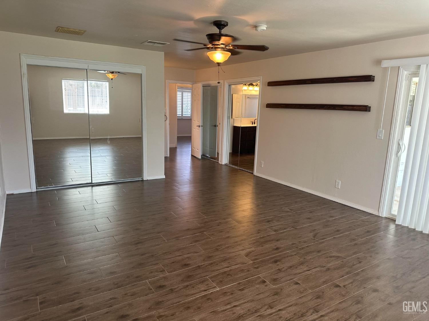 Undisclosed Address Bakersfield, CA 93306 - Photo 14 of 27 a view of an empty room with window and wooden floor