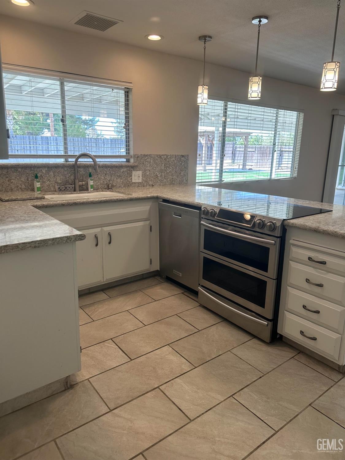 Undisclosed Address Bakersfield, CA 93306 - Photo 17 of 27 a kitchen with a stove a sink and a window