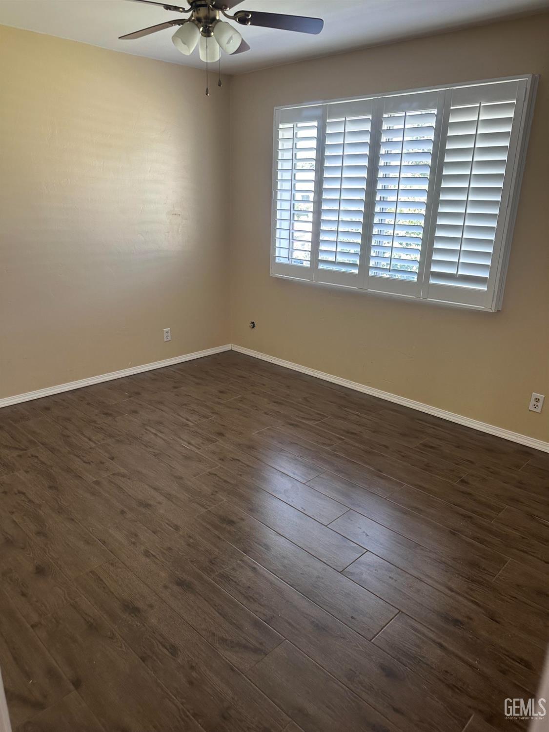 Undisclosed Address Bakersfield, CA 93306 - Photo 7 of 27 an empty room with wooden floor and windows