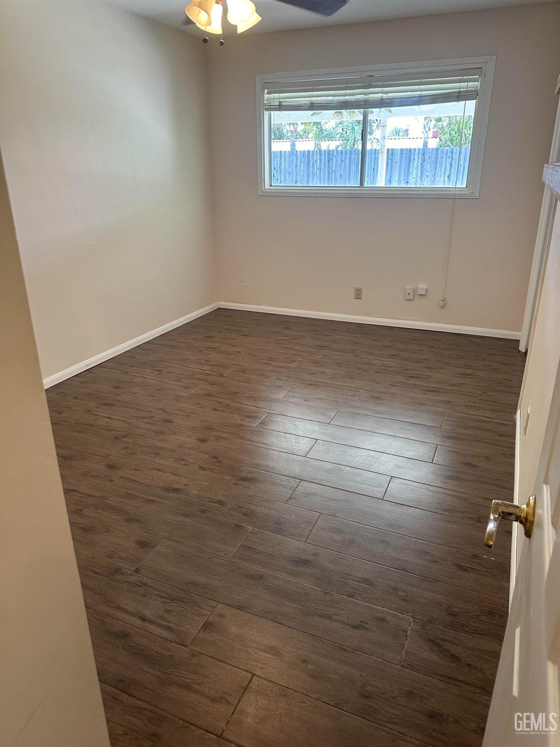 Undisclosed Address Bakersfield, CA 93306 - Photo 8 of 27 an empty room with wooden floor and windows