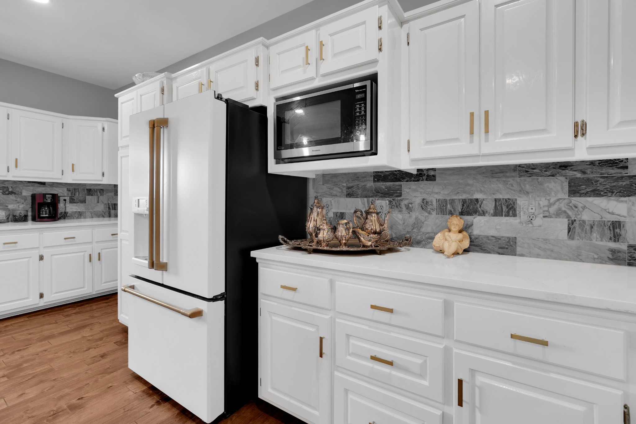 1191 Knights Church Road Decherd, TN 37324 - Photo 15 of 58 a kitchen with granite countertop white cabinets white stainless steel appliances and wooden floor