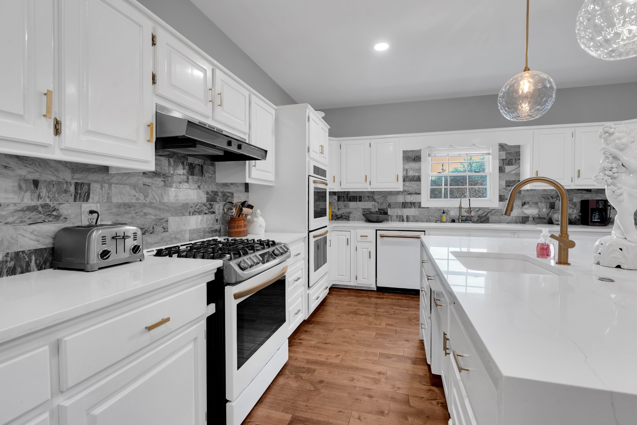 1191 Knights Church Road Decherd, TN 37324 - Photo 16 of 58 a kitchen with stainless steel appliances a white cabinets and wooden floor