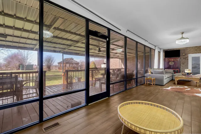 a view of a room with furniture and wooden floor