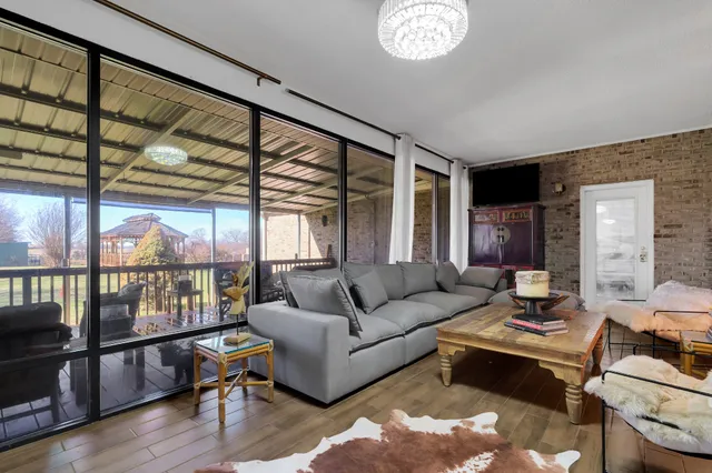 a backyard of a house with table and chairs