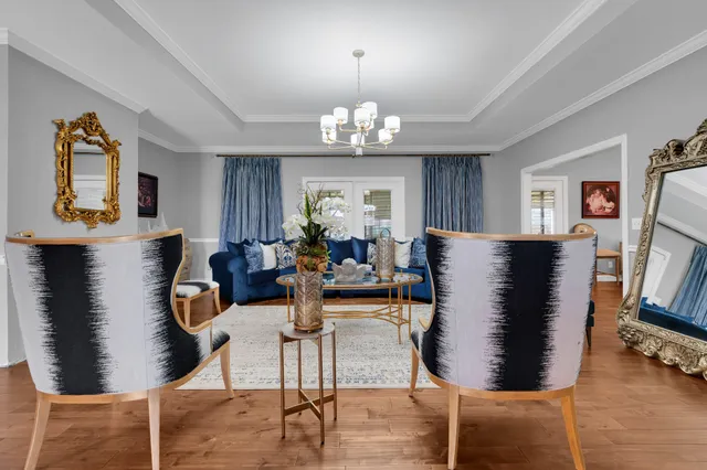 a view of a dining room with furniture and chandelier
