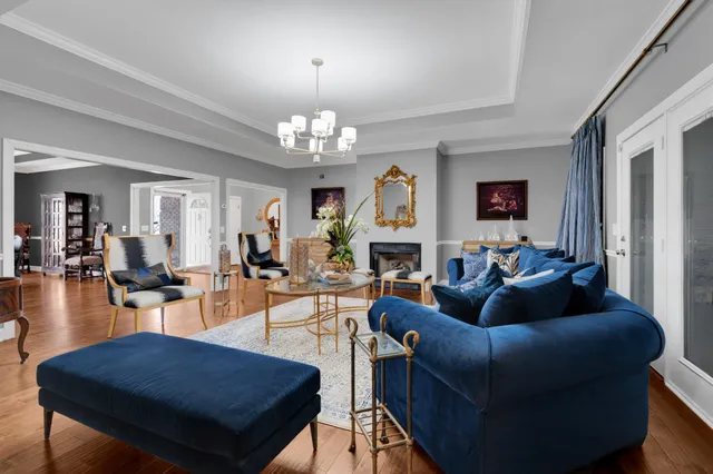 a dining room with furniture a chandelier and wooden floor