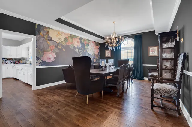 a kitchen with sink a dining table and chairs