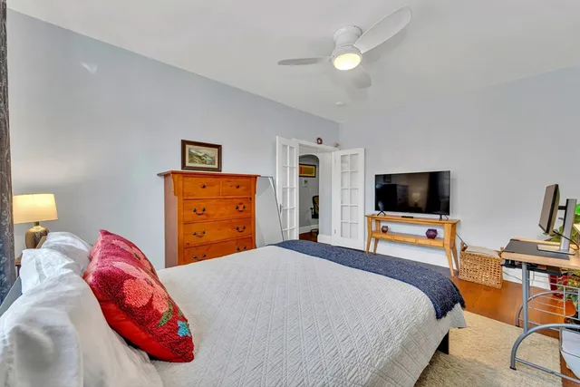 a bedroom with a bed and a flat screen tv