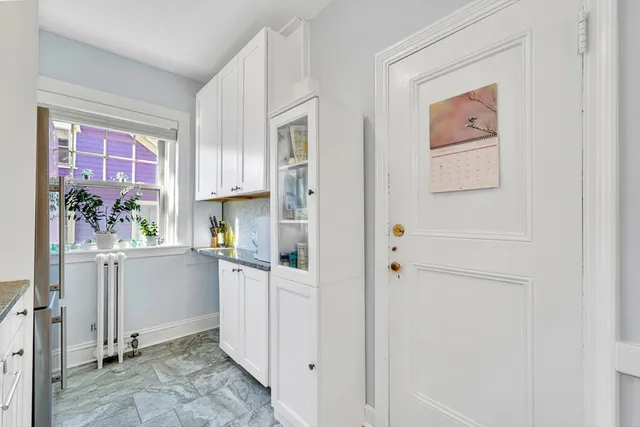 a kitchen with a refrigerator and cabinets