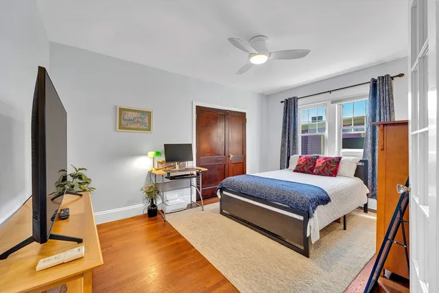a living room with a bed furniture and a window