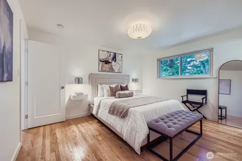 a bedroom with a bed and a painting on the wall