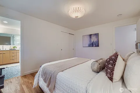 a bedroom with a large bed and a chandelier