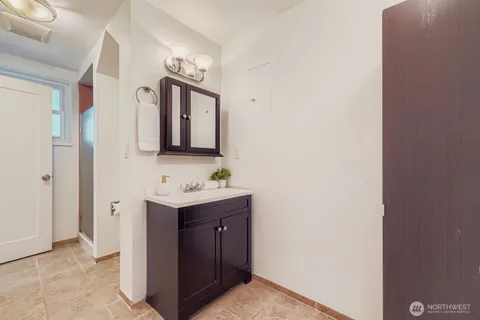 a bathroom with a toilet a sink and mirror