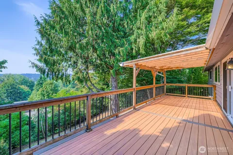 a view of balcony with wooden floor and fence