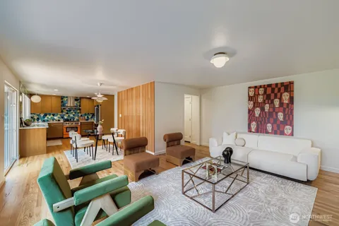 a living room with furniture and a view of kitchen