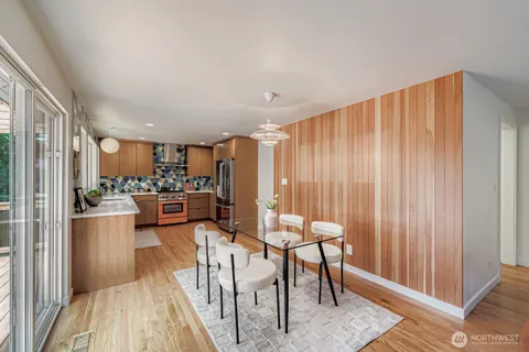 a view of a dining room with furniture window and wooden floor