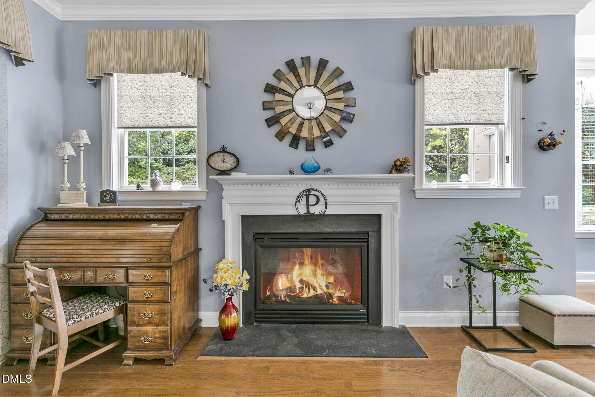 9805 Carlyle Hills Way Raleigh, NC 27560 - Photo 11 of 42 a living room with a fireplace with a large window