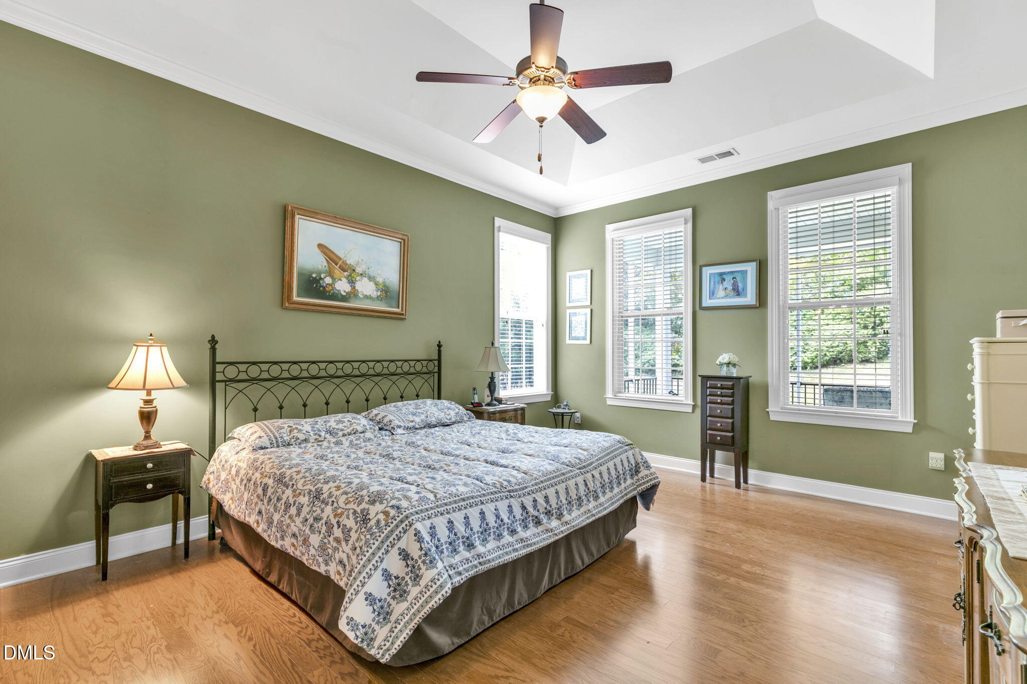 9805 Carlyle Hills Way Raleigh, NC 27560 - Photo 19 of 42 a bedroom with a bed painting on wall and a large window