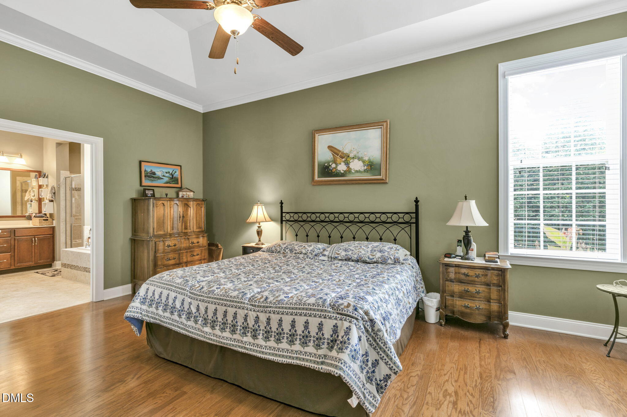 9805 Carlyle Hills Way Raleigh, NC 27560 - Photo 21 of 42 a bedroom with a bed and a large window