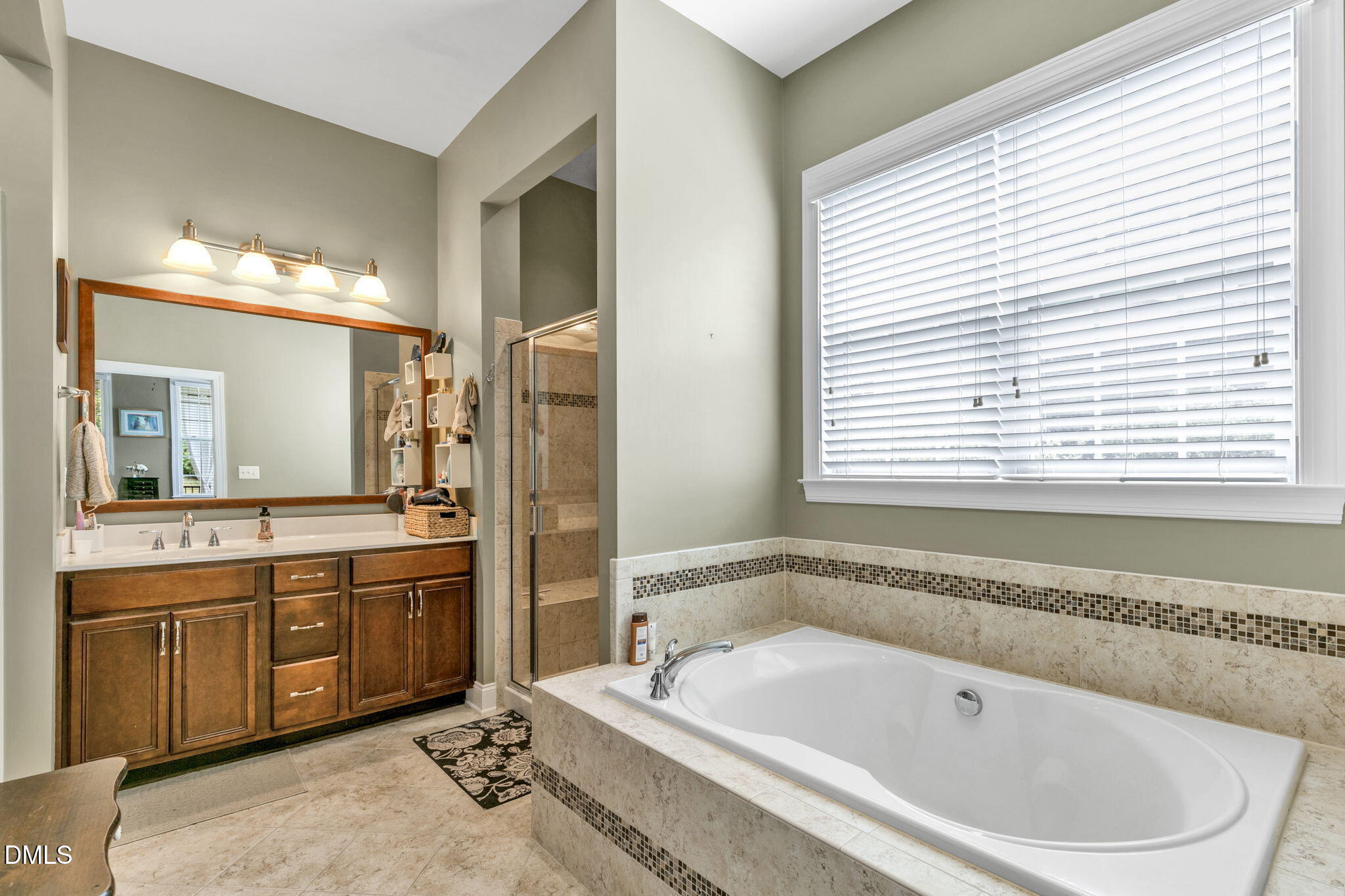 9805 Carlyle Hills Way Raleigh, NC 27560 - Photo 22 of 42 a spacious bathroom with a tub a sink and a mirror