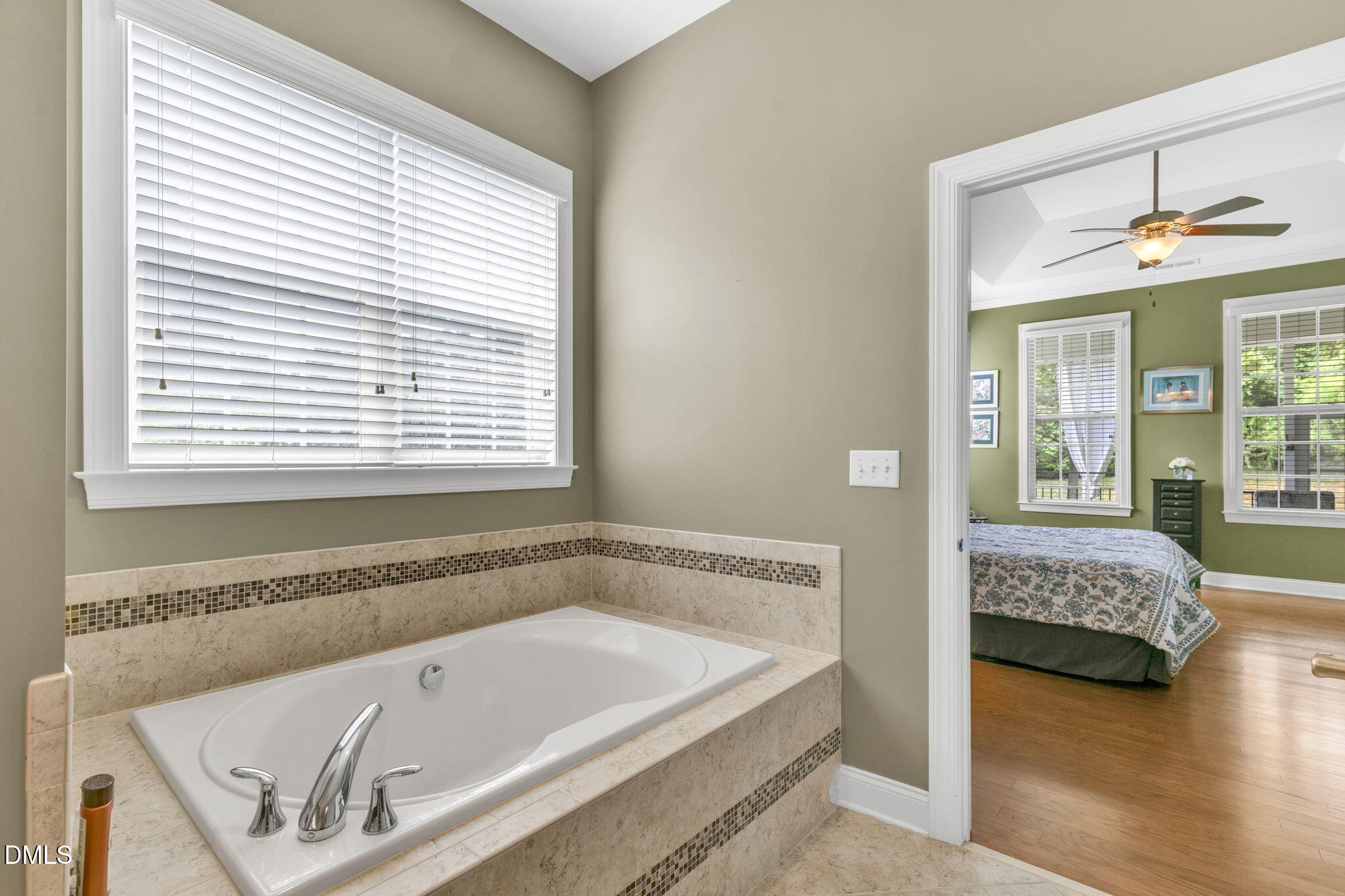 9805 Carlyle Hills Way Raleigh, NC 27560 - Photo 24 of 42 a bathroom with a tub a sink and a window