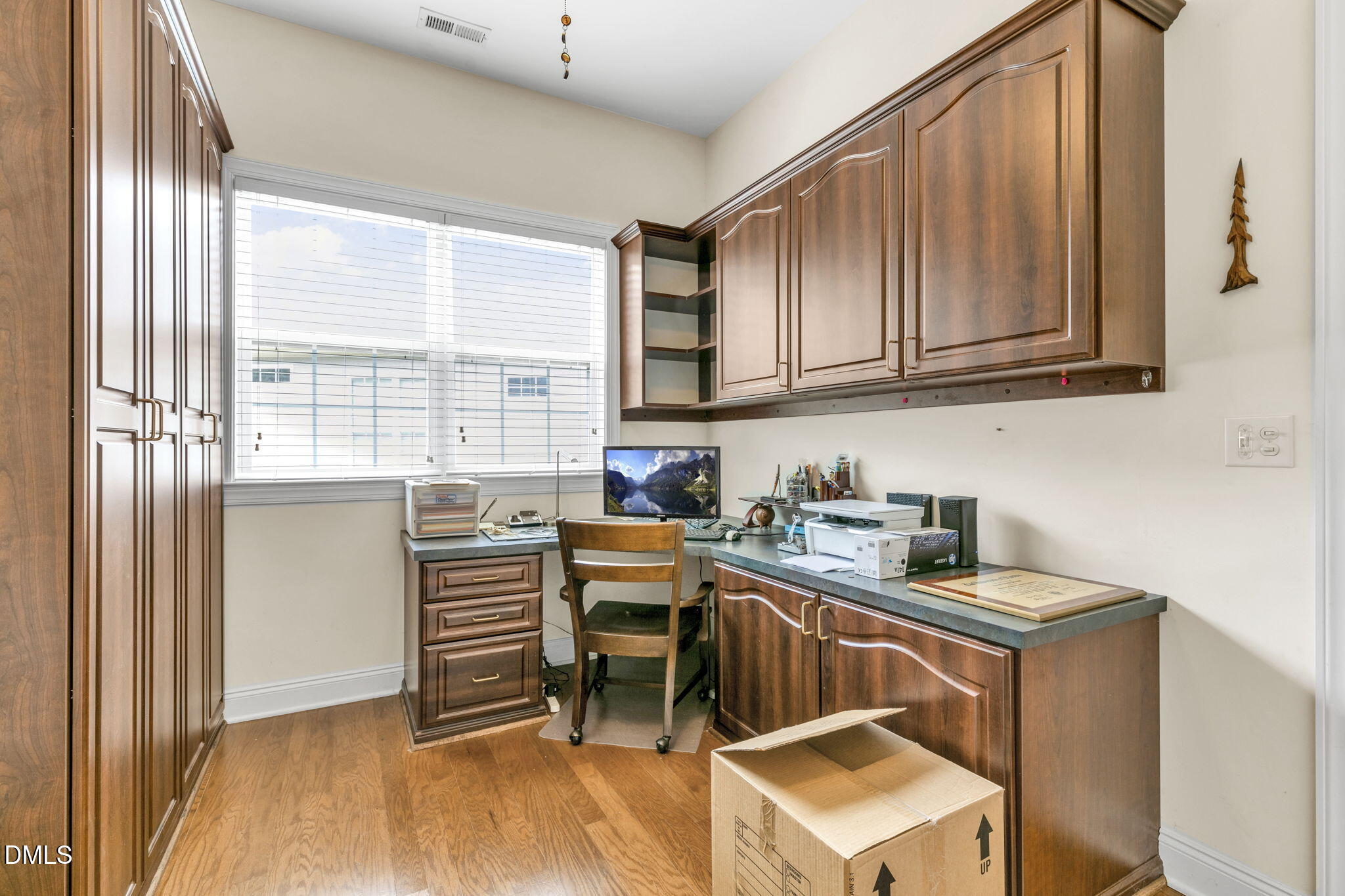 9805 Carlyle Hills Way Raleigh, NC 27560 - Photo 30 of 42 a room with a sink cabinets and wooden floor