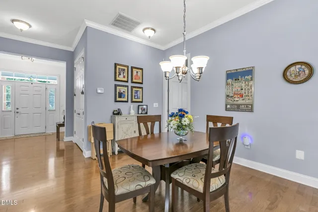 a view of a dining room with furniture and chandelier