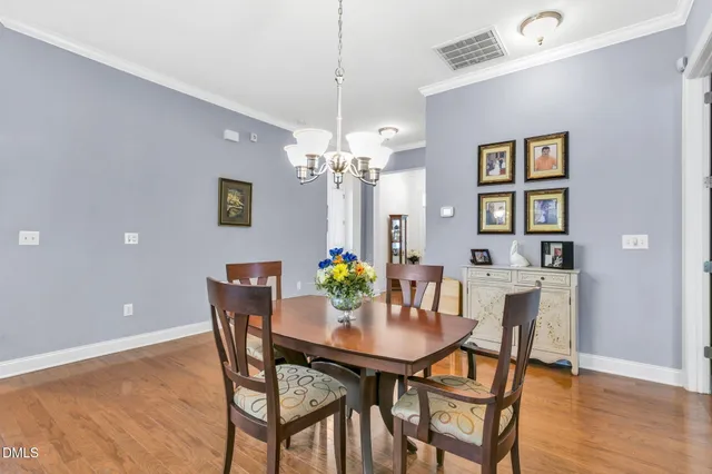 a dining room with furniture and chandelier