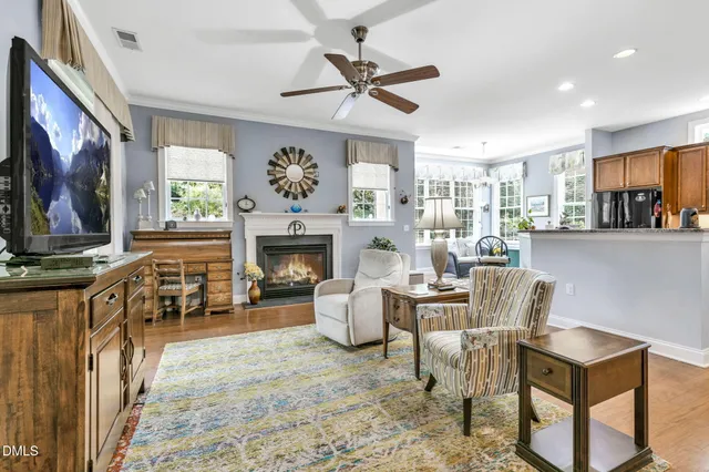 a living room with furniture a fireplace and a flat screen tv