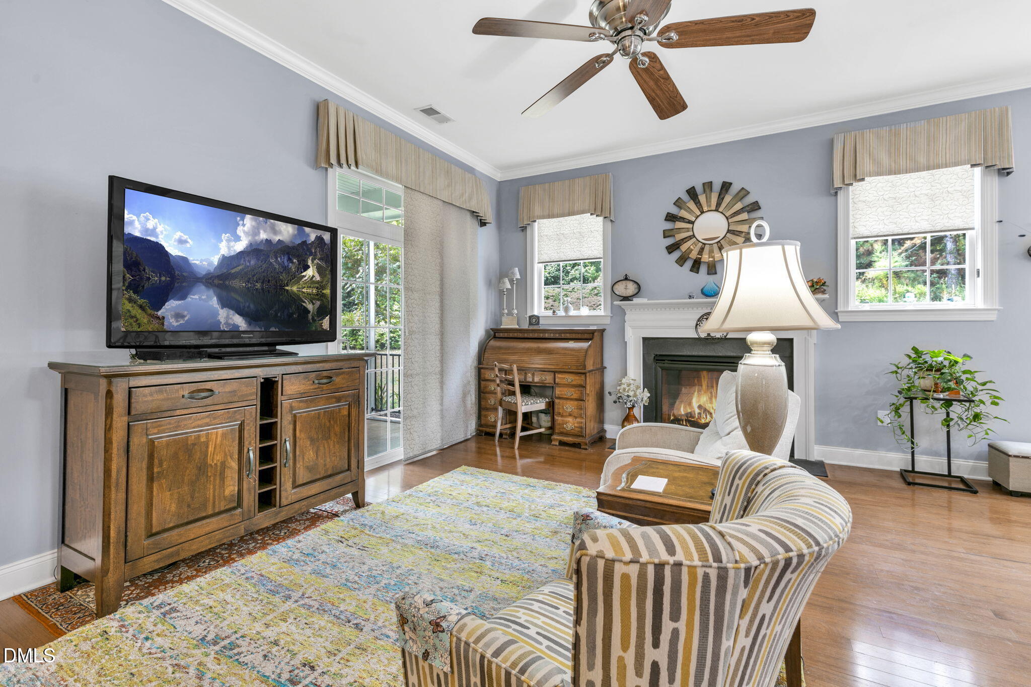 9805 Carlyle Hills Way Raleigh, NC 27560 - Photo 9 of 42 a living room with furniture a fireplace and a flat screen tv