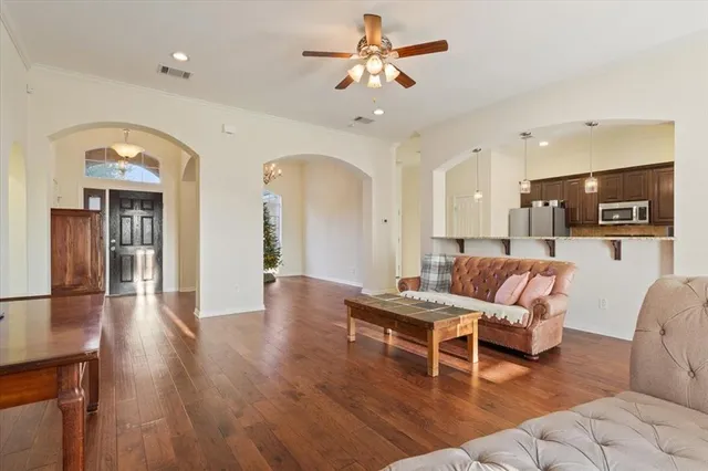 a living room with furniture and kitchen view