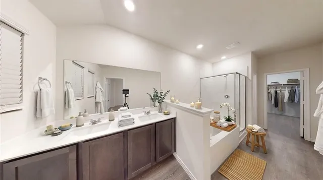 a large bathroom with a double vanity sink a large mirror and a shower