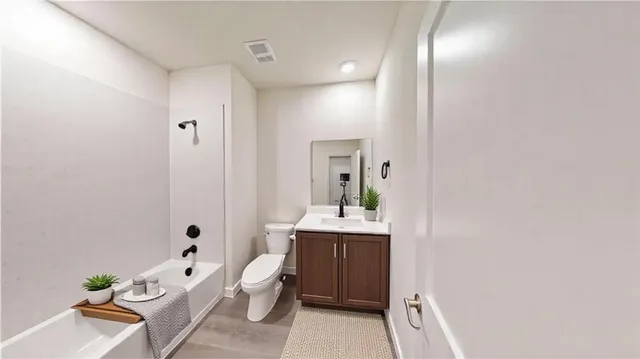 a spacious bathroom with a bathtub sink and toilet