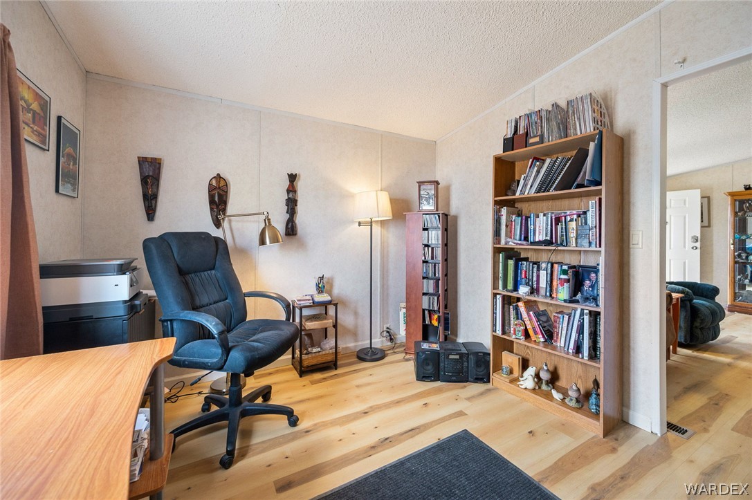 2465 Egar Road Golden Valley, AZ 86413 - Photo 21 of 98 This room features light-toned wood flooring and a built-in bookshelf