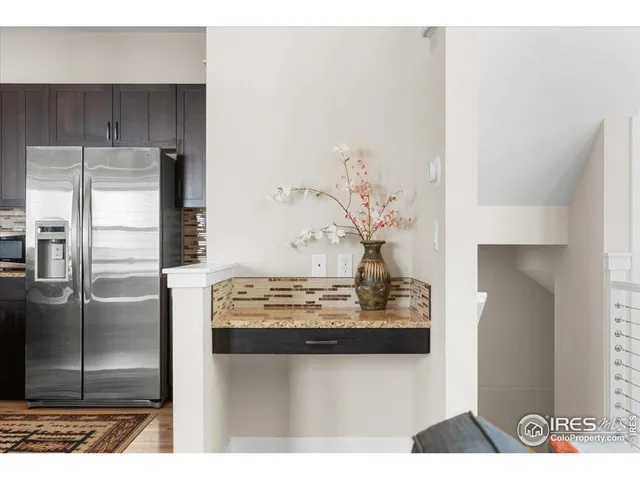 a kitchen with stainless steel appliances kitchen island granite countertop a refrigerator and a stove