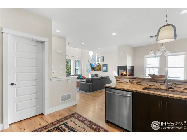 a kitchen with a sink cabinets and wooden floor