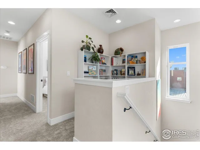 a room with stainless steel appliances kitchen island a refrigerator and a cabinets