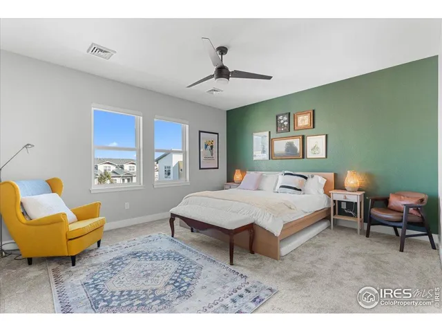 a spacious bedroom with a bed a couch and a window