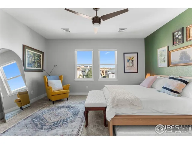 a bedroom with a bed a couch and a window