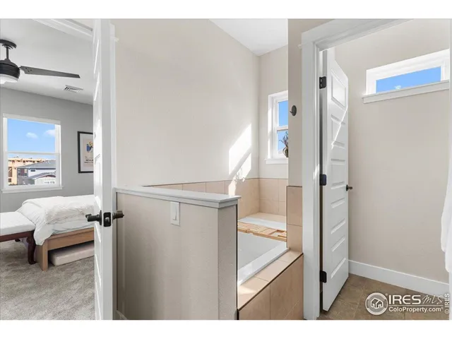 a view of a bedroom with wooden floor and furniture